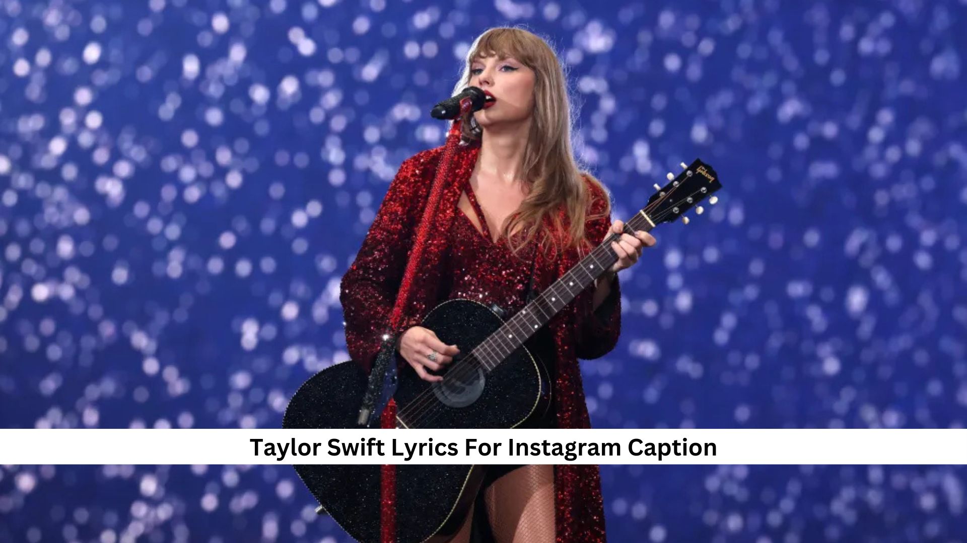 Singer in red dress playing a black guitar on stage with starry background.